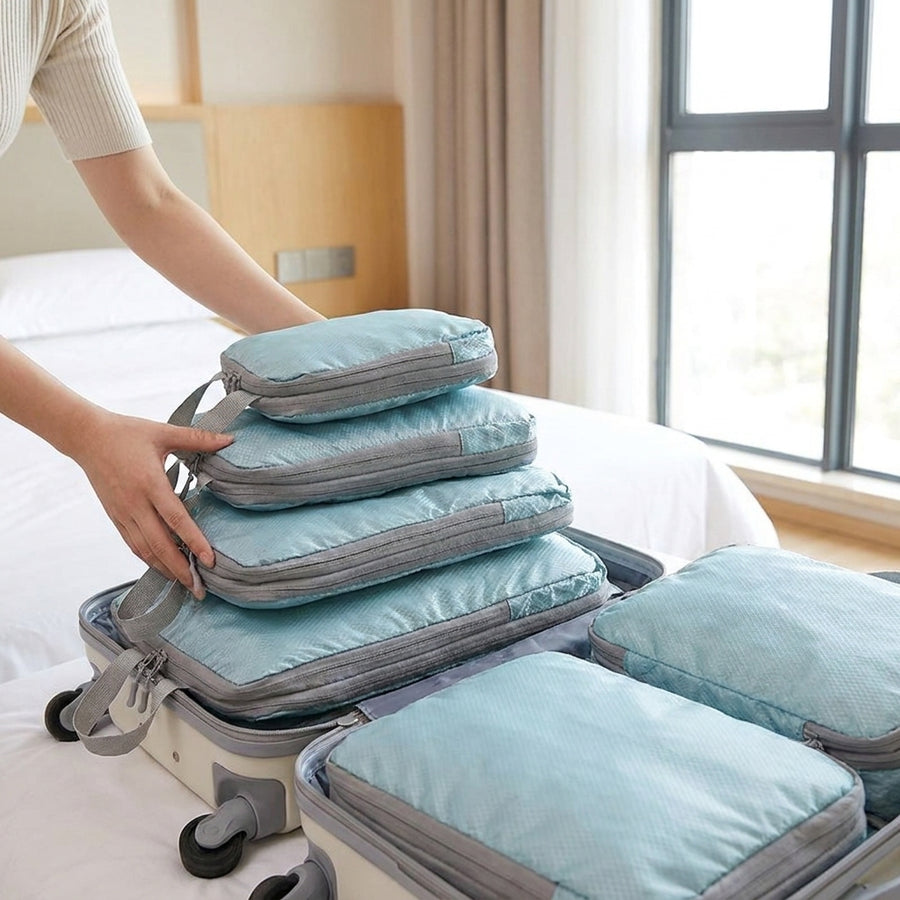 Compression packing cubes laid out for a long flight